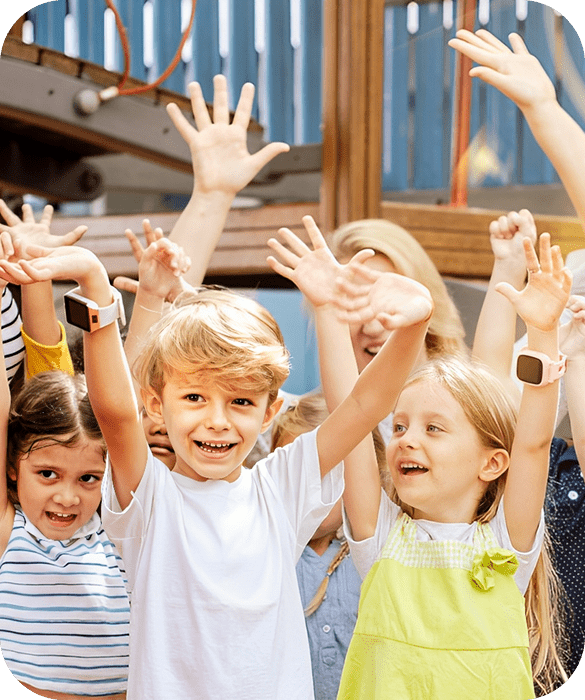 Children raising hands in a playful group.